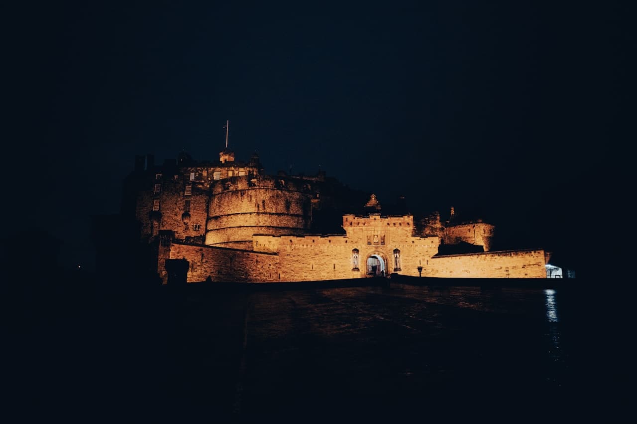 Dark medieval castle silhouetted against a dramatic cloudy sky, evoking the gothic atmosphere of Bram Stoker's Dracula